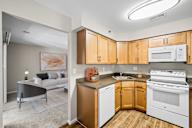 A kitchen with wooden cabinets and white appliances.