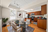A modern kitchen with a dining table set for two.