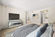 A bedroom with a large bed and a television.
