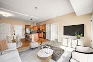 A living room with a white couch and a coffee table.
