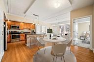 A modern kitchen with a dining table and chairs.