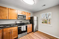 A kitchen with wooden cabinets and stainless steel appliances.