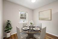 A dining room with a table set for four.