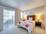 Studio Apartments in San Jose CA - Terra House - An interior shot of the bedroom featuring a bed and spacious closet