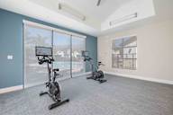 A room with exercise bikes and a view of the outside.