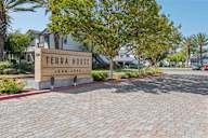 A sign that says Terra House in front of some buildings.