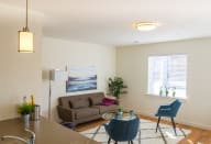 a living room with a couch chairs and a coffee table