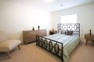a bedroom with a bed and a dresser