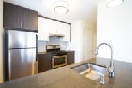 a kitchen with a sink stove and refrigerator