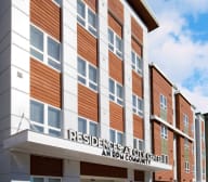 a building with a sign that says residents at city center an appy community