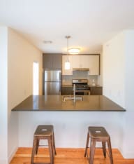 a kitchen with an island and stools