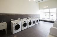 a row of washing machines in a laundromat
