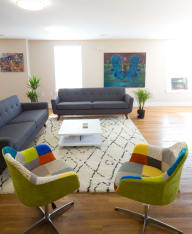 a living room with couches chairs and a coffee table