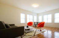 a living room with a couch and chairs