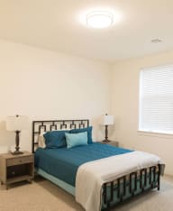a bedroom with a bed and two night stands