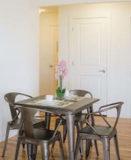 a small dining room with a table and chairs