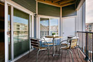 A table with chairs is on a deck.