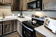Kitchen with stainless steel appliances at Sterling Prairie Trail in Ankeny, IA