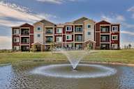 A large building with a fountain in front of it.
