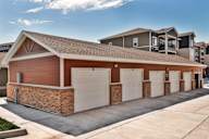 A row of garage doors in front of a building.