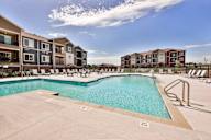 A swimming pool surrounded by apartment buildings.