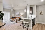 A modern kitchen with a bar stool and a countertop.