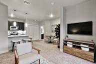 A modern living room with a grey sofa and a wooden coffee table.