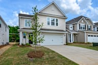 a house with a white garage door and a lawn