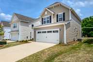 a house with a driveway and a garage door