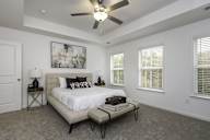 a bedroom with a bed and a ceiling fan