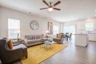 Spacious living area featuring contemporary design elements, including comfortable seating and abundant natural light