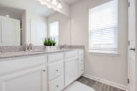 Spa-inspired bathroom featuring an extended double vanity and abundant storage in a clean, modern design
