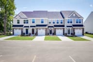 Beautifully maintained townhome building with classic styling and pristine exterior finishes