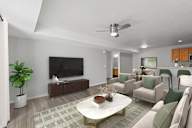 A living room with a white coffee table and a green couch. at Eagles Landing, Ammon, ID, 83406