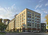 a rendering of a new apartment building on a city street at The Lucy Boise Apartments, Boise
