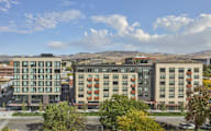 an aerial view of an apartment building in the city at The Lucy Boise Apartments, Idaho