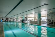 a swimming pool in a gym with a blue water at The Lucy Boise Apartments, Boise