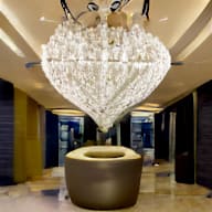 a chandelier in the lobby of the ritz carlton kuala lumpur
