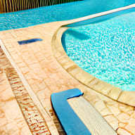 a pair of blue pool slides in a swimming pool