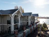 A row of houses with a body of water in the background.