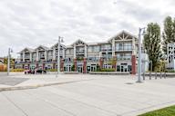 A large building with a parking lot in front.