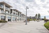 A modern building with a long walkway in front.