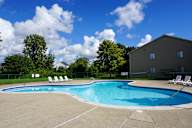 Swimming Pool and pool chairs with apartment in background, at Garfield Commons