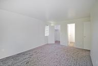 A large empty room with a carpeted floor and white walls.