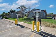 A parking lot with a charging station for electric vehicles.