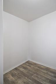 A room with a wooden floor and white walls.