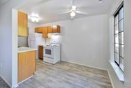 A kitchen with a refrigerator, oven, and microwave.