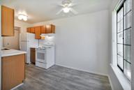 A kitchen with a refrigerator, microwave, and oven.
