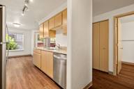 a kitchen with wood flooring and a stainless steel dishwasher