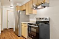 a kitchen with stainless steel appliances and wooden cabinets